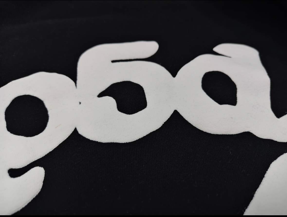 black Sp5der hoodie features reflective white graphic prints of the brand name and stars