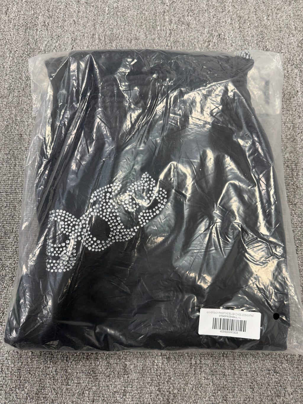 Sp5der OG Web Sweatpants in black, featuring distinctive rhinestone logo and star graphics