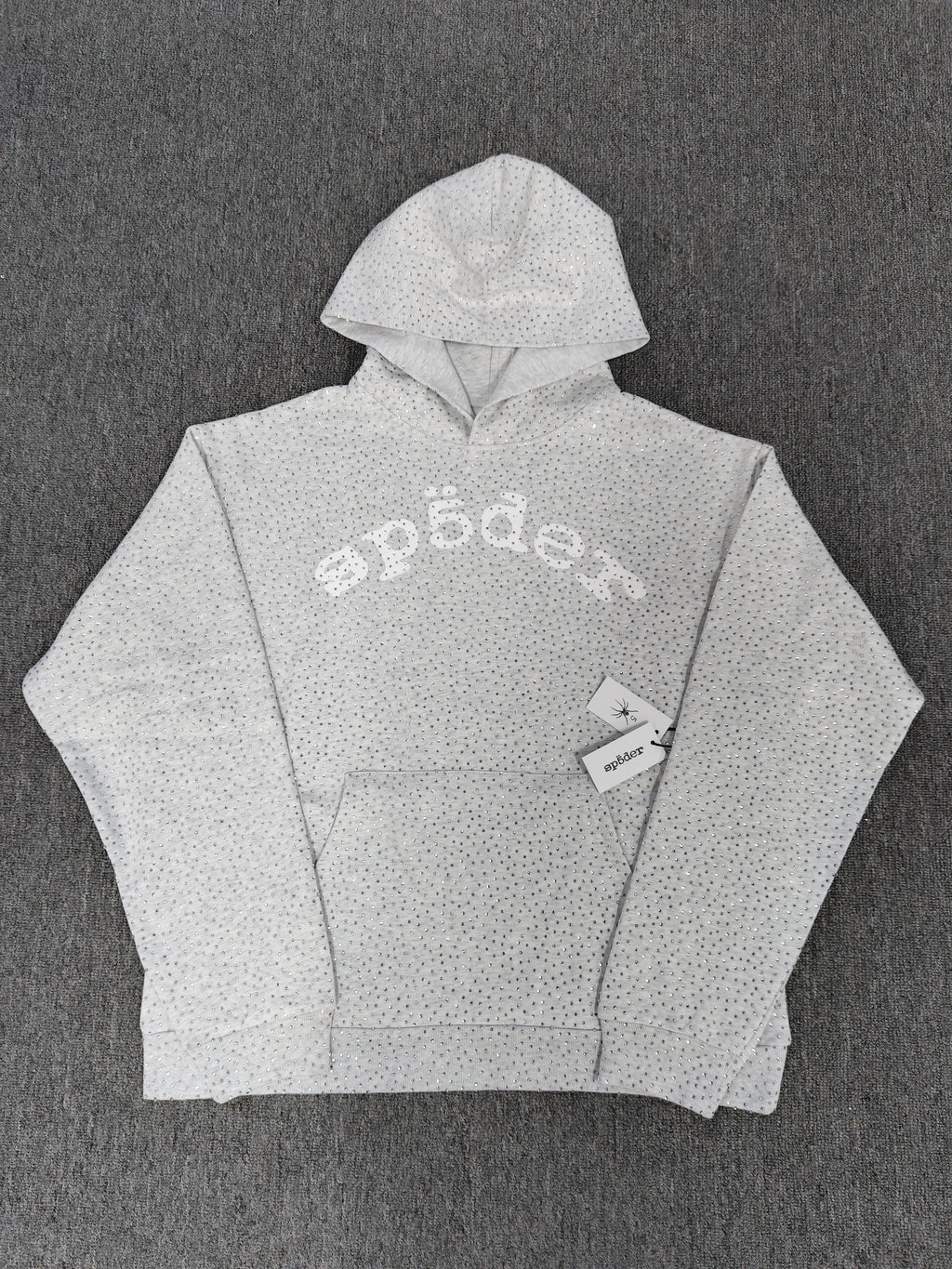 a Sp5der VVS Hoodie in Heather Grey, recognized by its all-over tonal rhinestones and arch logo