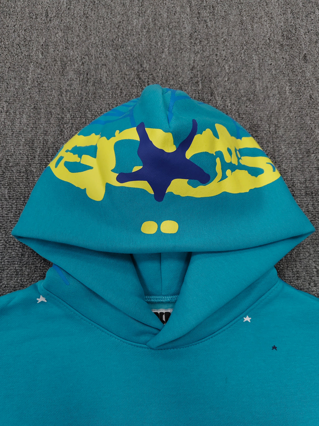 Sp5der Heavy Web Hoodie in 'Cyan' is designed with a striking blue color and a signature web-inspired graphic on the hood