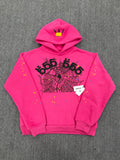 pink Sp5der graphic-print hoodie features a black spiderweb design on the front with scattered multicolored stars