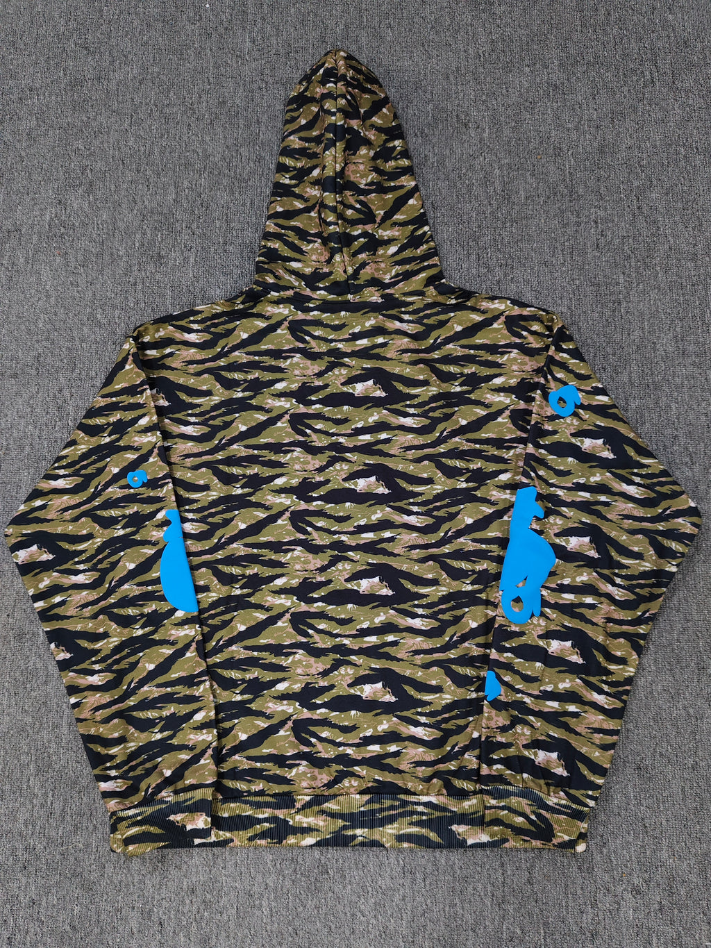 Sp5der Beluga hoodie features a distinct tiger camo pattern and vibrant blue star graphics