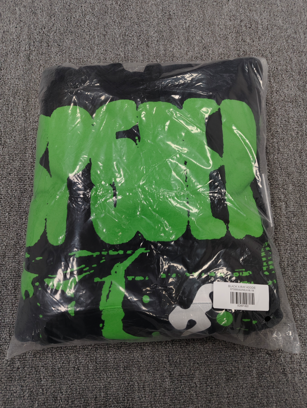 black Sp5der X-Ray Hoodie featuring prominent neon green slime-style graphics