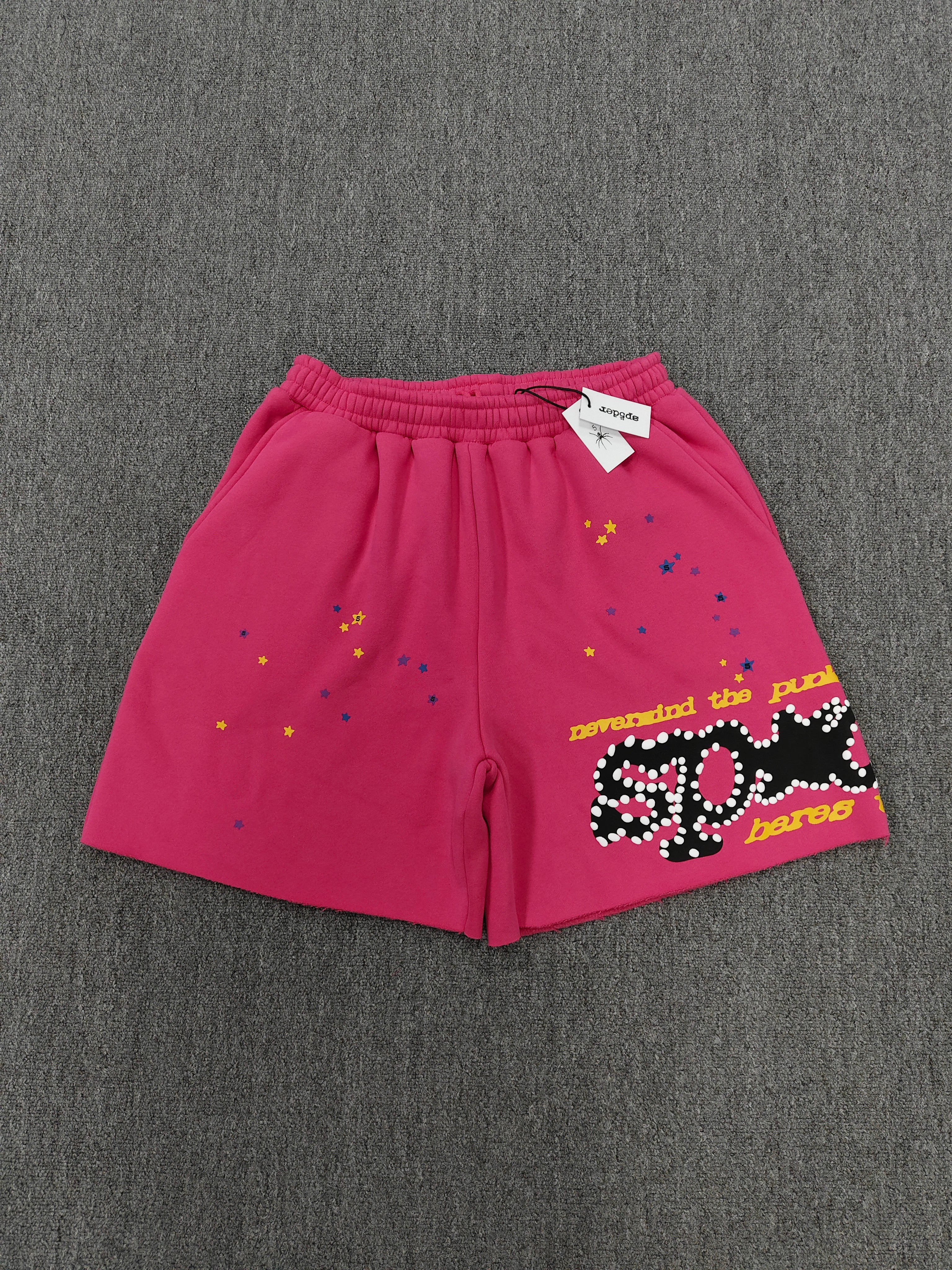 pink shorts Sp5der "Punk V2" collection, featuring rhinestone branding and scattered star graphics