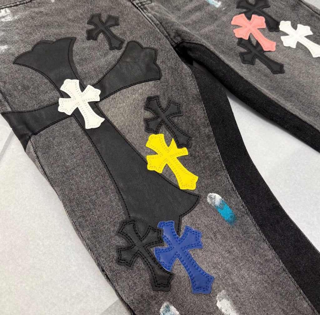 Chrome Hearts distressed jeans featuring a multicolor patchwork application of their iconic cross motif.