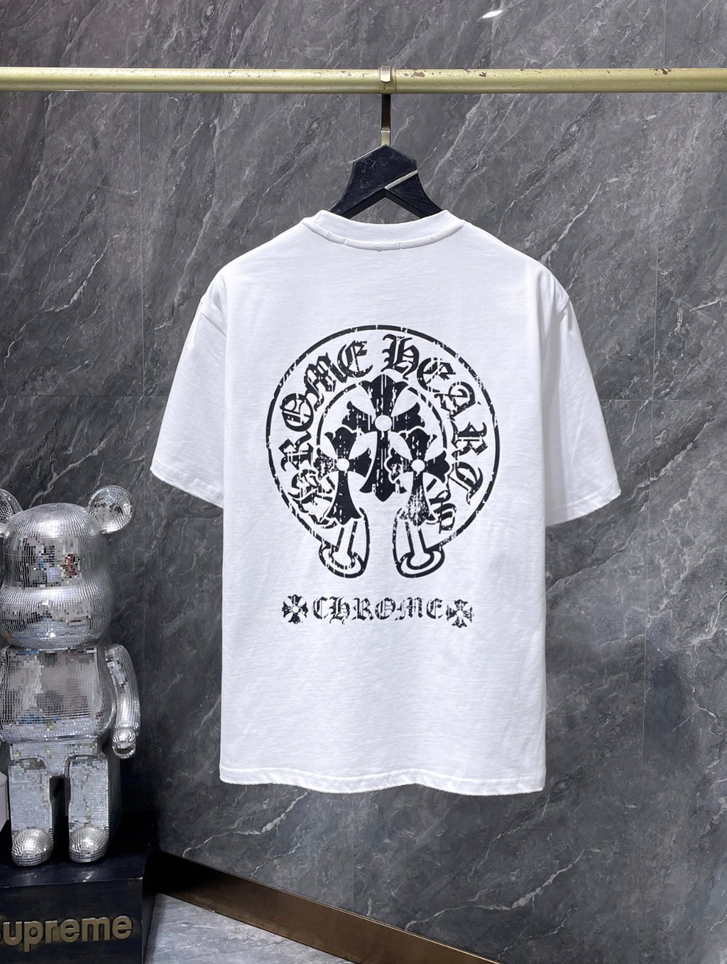 These are Chrome Hearts T-shirts featuring a large Triple Cross Horseshoe graphic in black or white