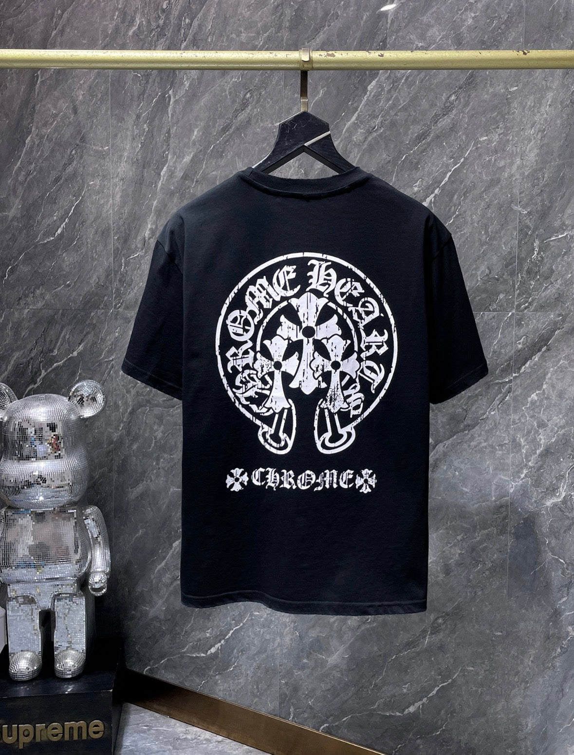 These are Chrome Hearts T-shirts featuring a large Triple Cross Horseshoe graphic in black or white