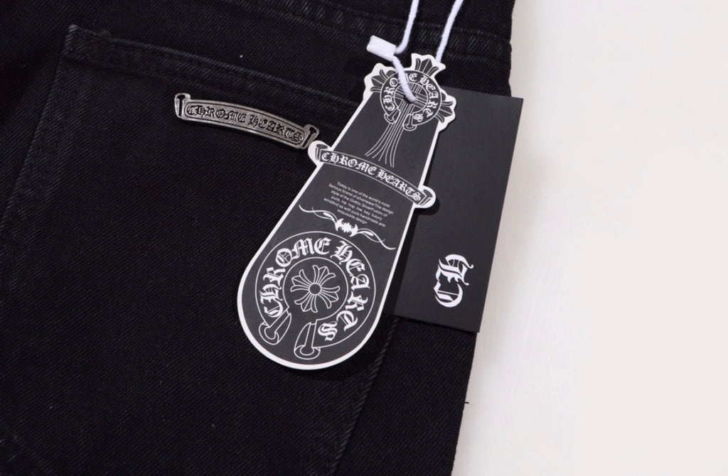 Chrome Hearts jeans featuring pink leather and checkered pony hair cross patches